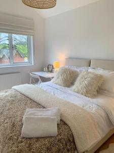 a bedroom with a large bed with a window at South Downs View in West Meon