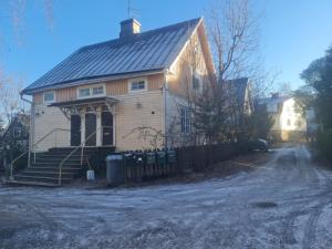 a white house with a black roof on a street at Lonely Planet Turku 2 in Turku