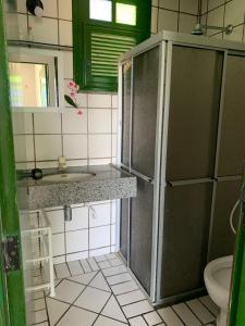 a small bathroom with a sink and a toilet at Porto Canoa, Chios Ap 102 , Aracati, CE in Aracati