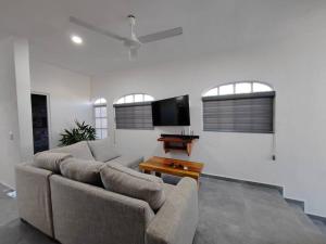 a living room with a couch and a flat screen tv at Departamento 2 Boulevard Manzanillo in Manzanillo