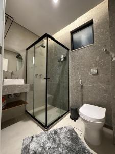 a bathroom with a shower and a toilet and a sink at Belíssimo apartamento com vista para a praia de Copacabana e cristo in Rio de Janeiro +5 photos