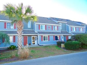 a blue house with red doors and a palm tree at A Wave From It All-5J GCR in Myrtle Beach