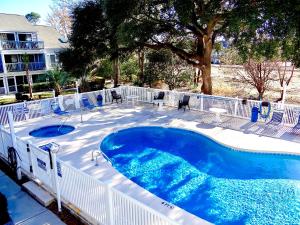 a large swimming pool with a white fence around it at A Wave From It All-5J GCR in Myrtle Beach