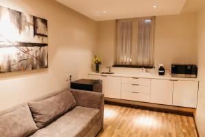 a living room with a couch and a kitchen at Hotel Boutique Maria in Morelia