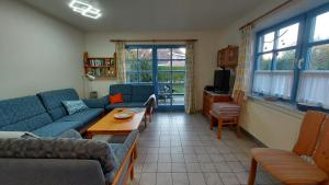 a living room with a couch and a coffee table at Haus Nika in Carolinensiel in Carolinensiel