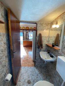a bathroom with a sink and a toilet and a mirror at LoView Avlona 