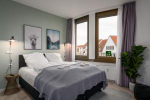 a bedroom with a bed and a large window at BRIGHT Lippstadt Klusetor in Lippstadt