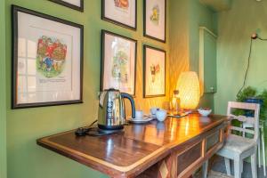 a wooden table with a tea kettle on top of it at The Old Goathouse in Kildare