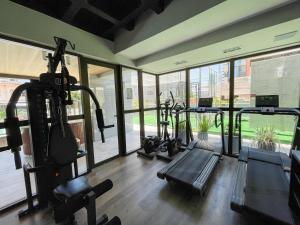 a gym with several treadmills and elliptical machines at Design 205 - Quarto e Sala 42 M2- NOVO - Ponta Verde - Maceió in Maceió