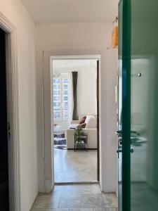 - un couloir avec un salon doté d'un canapé dans l'établissement Cosy T2 in Neuilly sur Seine metro 1, à Neuilly-sur-Seine