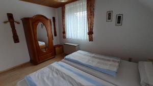a bedroom with a bed and a large mirror at Ferienwohnung am Deister mit großem Balkon in Springe