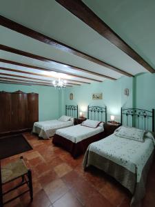 מיטה או מיטות בחדר ב-Casa rural Villa Dulcinea