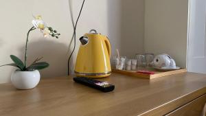 a yellow blender sitting on top of a wooden table at Silver Eagle in Dublin