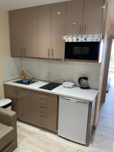 a kitchen with a sink and a counter top at Neraida Central Apartment in Loutraki