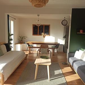 a living room with a bed and a table at La Tanière aux Loups in Montévrain