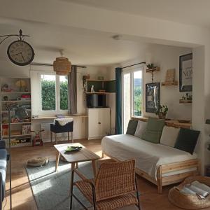 a living room with a bed and a table at La Tanière aux Loups in Montévrain