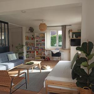 a living room with a couch and a table at La Tanière aux Loups in Montévrain