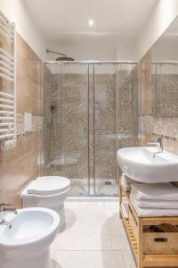 a bathroom with a shower and a toilet and a sink at Colibrì Prestige Rooms - Roman Ruins View in Cagliari