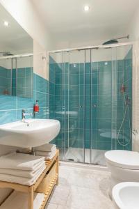 a bathroom with a sink and a shower at Colibrì Prestige Rooms - Roman Ruins View in Cagliari