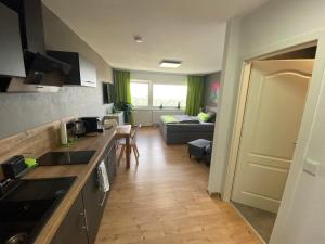 a kitchen with a counter top and a living room at Apartment Stadtblick in Braunschweig