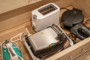 a toaster and other appliances sitting on a drawer at Amazing and secluded northern light apartment near sea and city! in Selnes