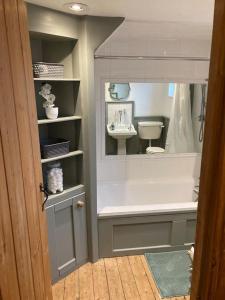 a bathroom with a toilet and a sink at Pieman's Cottage - Pulborough, West Sussex Cottage - sunny courtyard in Pulborough