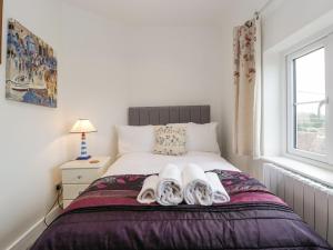 a bedroom with a bed with towels on it at Celia's View in Langport