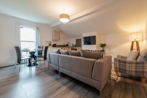 a living room with a couch and a table at Crosby Apartments in Liverpool