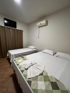 Ένα ή περισσότερα κρεβάτια σε δωμάτιο στο Hotel Paraiso - Fácil acesso as faculdades e FarmShow