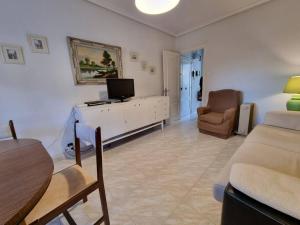 a living room with a tv and a couch and a table at R2R - Apartamento Somo - C09A01 in Somo