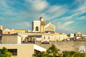 a building with a church on top of it at Colibrì Prestige Rooms - Roman Ruins View in Cagliari
