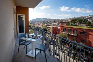 a balcony with a table and chairs and a view at Lady Mary's Luxury Suites in Naples