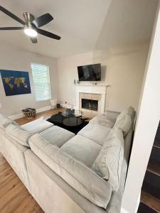 a living room with a white couch and a fireplace at Sweet Home Atlanta in Atlanta