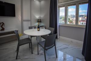 a dining room with a table and chairs and a window at Lady Mary's Luxury Suites in Naples