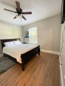 a bedroom with a bed and a ceiling fan at Sweet Home Atlanta in Atlanta