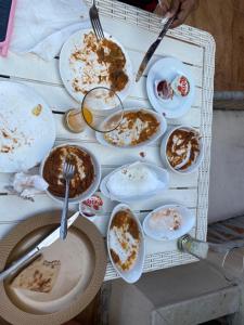 a table full of plates of food with forks at PYRAMIDS TOP IN in Cairo