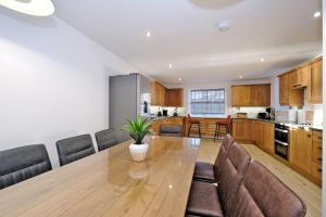 a kitchen and dining room with a wooden table and chairs at Rosebrae in Insch