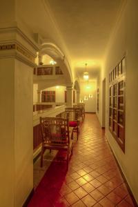 
a dining room with chairs and tables in it at The Fort Bungalow in Cochin
