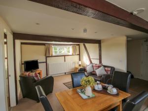 a living room with a table and a couch at The Grain Store in Nantwich