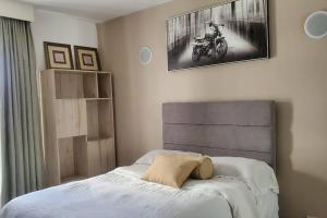 a bedroom with a bed with a motorcycle on the wall at Astoria 2BR Penthouse [Views of Bliss] in Nairobi