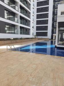 a swimming pool in front of two tall buildings at Astoria 2BR Penthouse [Views of Bliss] in Nairobi