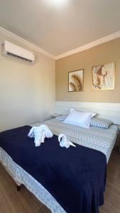 a bedroom with two towels on a bed at Suites Carioca in Porto De Galinhas