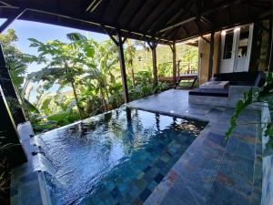 a swimming pool in the middle of a house at Location Open Sky in Deshaies