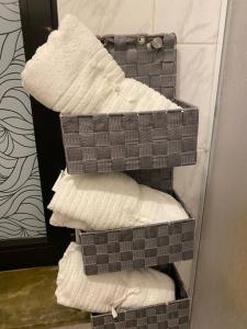 three baskets of towels are stacked in a bathroom at Cosy Studio in Kempen in Kempen