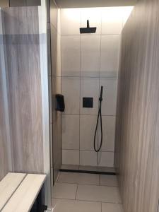 a shower with a glass door in a bathroom at Sunningdale Lodge,St Mellion,Cornwall-FreeGolf&Spa in St. Mellion