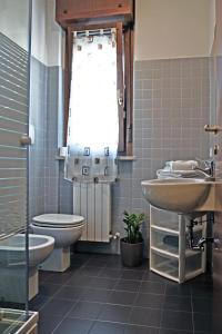 a bathroom with a toilet and a sink at Apartment Il Fiore in Bergamo