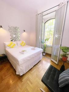 a bedroom with a white bed and a large window at Rome city center in Rome