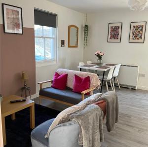 a living room with a couch and a table at Sunnyside Studio in Worthing