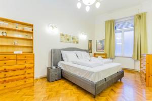 een slaapkamer met een groot bed en een dressoir bij Friend of Deák Ferenc in Boedapest