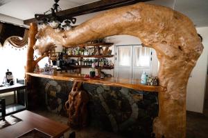 a bar with a large tree trunk behind it at CONACUL VANATORULUI, Borlova - MUNTELE MIC - Enduro Base in Borlova